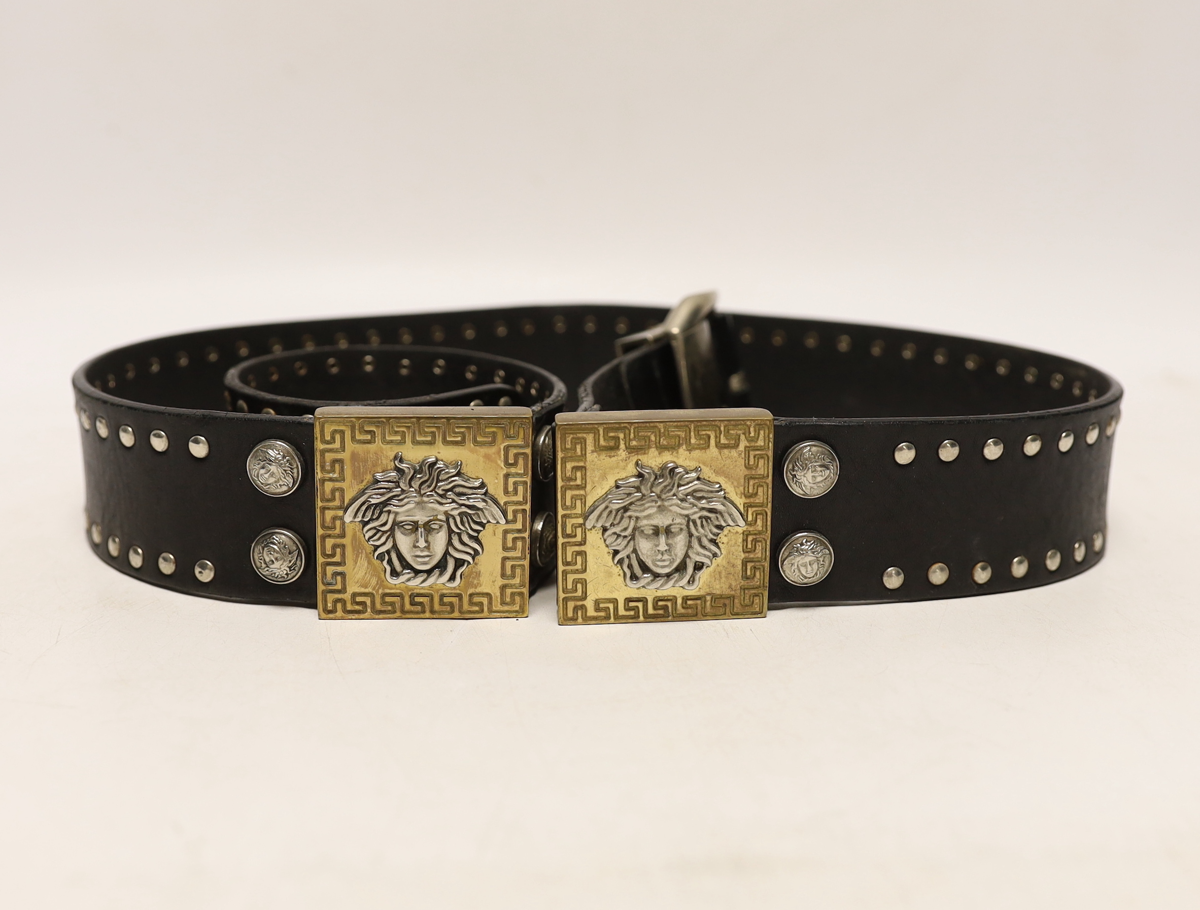 A Versace black leather belt with Medusa motif mounts, 102cm excluding buckle